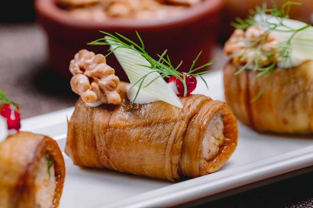 Eggplant roll with walnut, garlic, and greens