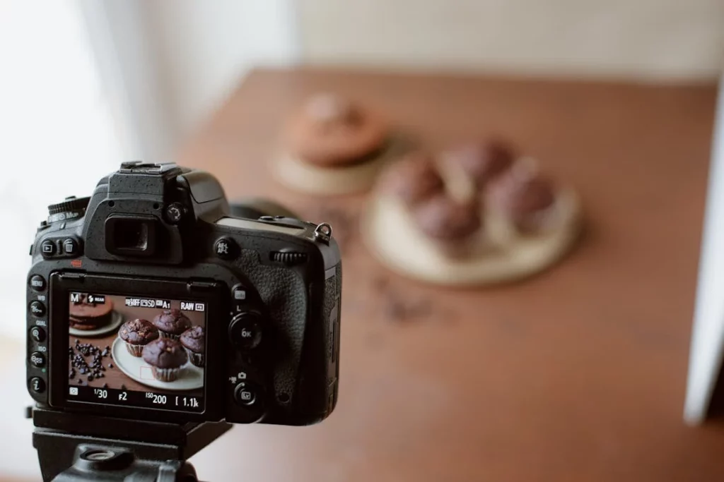  A camera capturing cupcakes exemplifying how one should not ignore background during restaurant food photography.