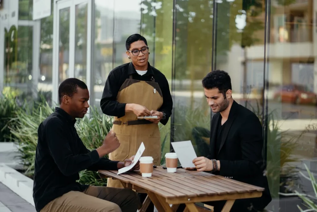 Waiter taking orders from customers