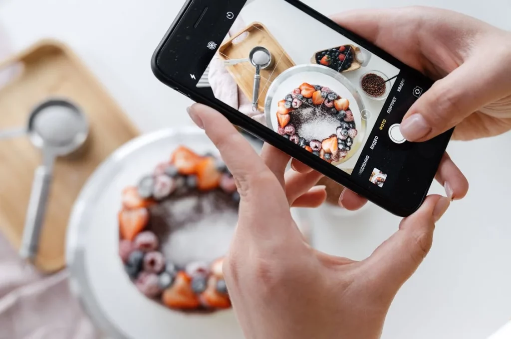 A woman taking food photography on iPhone using the grids feature