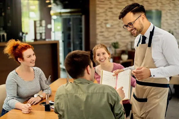 Restaurant staff suggesting restaurant specials ideas to diners