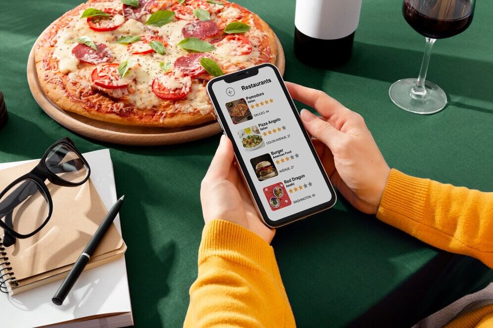 A person reviewing restaurants on phone, implying the importance of restaurant public relation