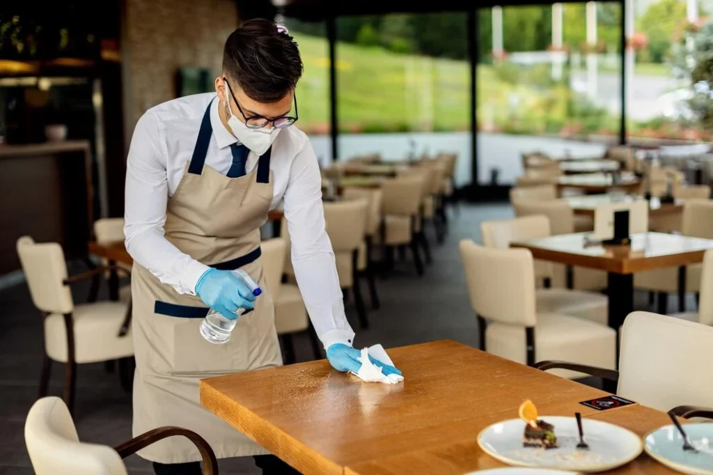 Restaurant staff prioritizes cleanliness, showing how to create an atmosphere in a restaurant through sanitization