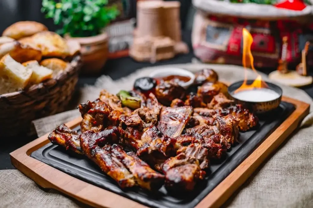 Sizzling platter of barbecued ribs, bread basket, and rustic decor capture the warm ambience of restaurant dining 