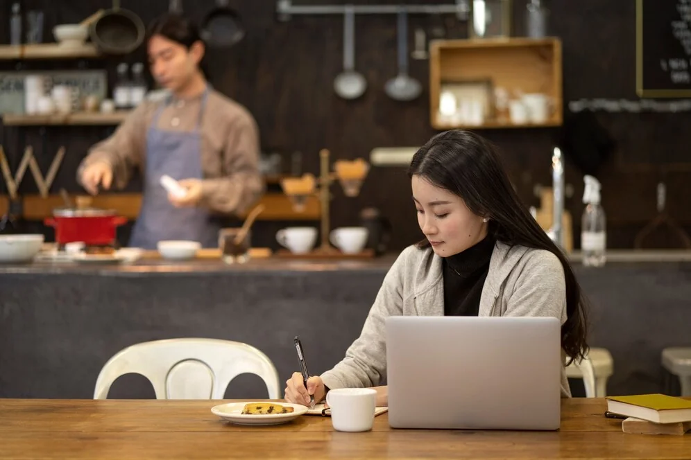 A woman working on a marketing plan for her small restaurant. ​​