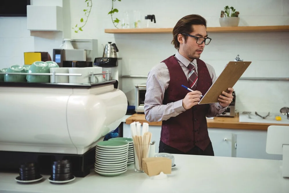 a restaurant manager looking at the inventory in his restaurant 